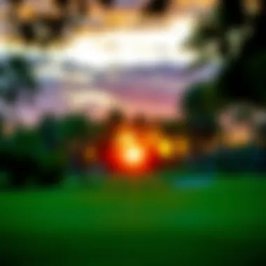 A vibrant sunset casting an orange hue over a picturesque golf green